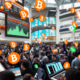 Create an image depicting a bustling financial district with digital displays showing rapidly increasing Bitcoin prices. In the foreground, a diverse group of enthusiastic investors is gathered around