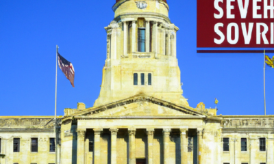 Create an illustration depicting the Nebraska Supreme Court building with a diverse group of people outside, symbolizing unity and empowerment. Among the crowd, include individuals representing ex-fel